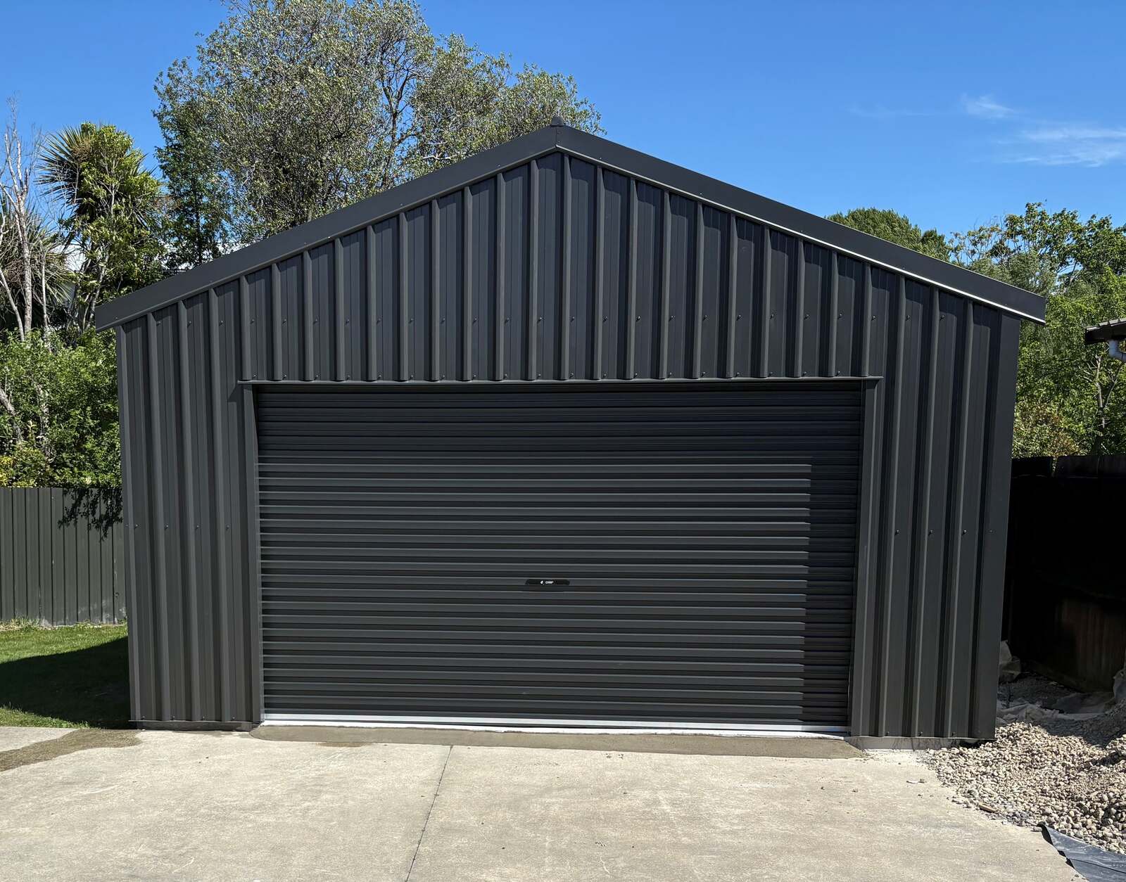 A finished charcoal Colorsteel kitset garage on a Canterbury section